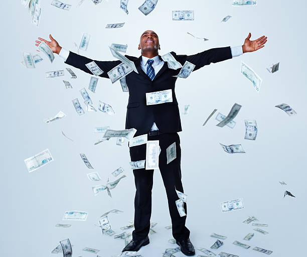 Happy successful business man under money rain against white  money rain stock pictures, royalty-free photos & images