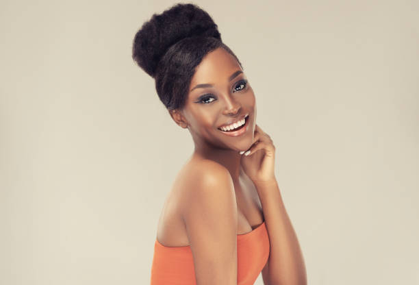 Happy, toothy smile, on the face of attractive  model with vibrant, melanin-rich skin tone. Afro beauty. stock photo