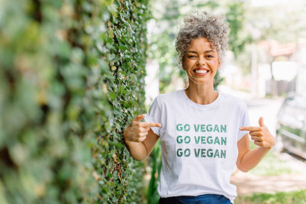 Happy vegan activist advocating for veganism outdoors stock photo