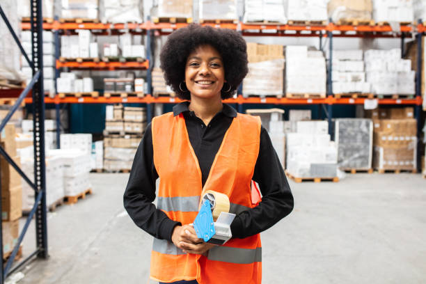 Happy warehouse worker in reflective clothing stock photo