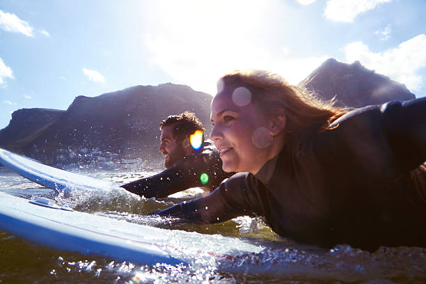 Shot of an athletic young couple surfing at their favourite beachhttp://195.154.178.81/DATA/i_collage/pu/shoots/785317.jpg