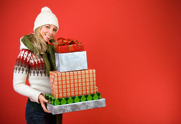 Happy Woman Carrying Many Christmas Gifts stock photo