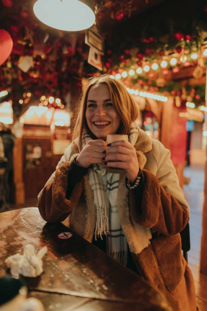 Happy woman drinking mulled wine at the Christmas market stock photo