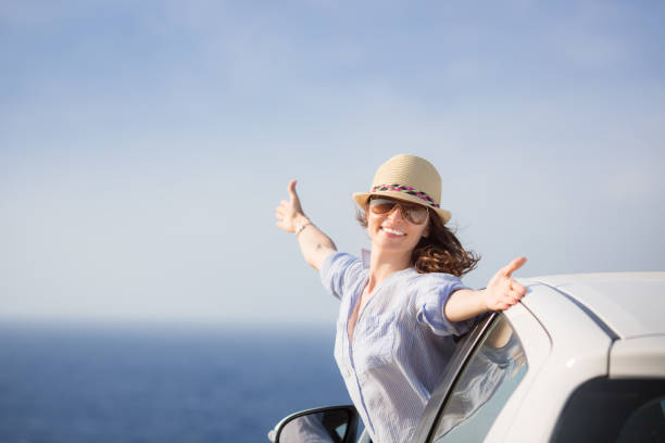Happy woman driver at the beach stock photo