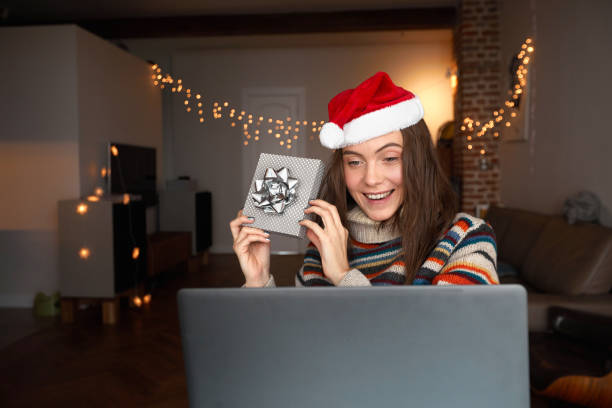 Happy woman making video call during Christmas celebration stock photo