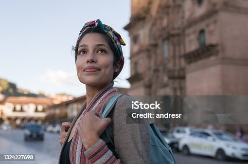 istock Happy woman sightseeing around Cusco around the Cathedral 1324227698