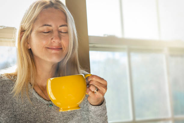 Happy Woman Smelling Morning Coffee stock photo