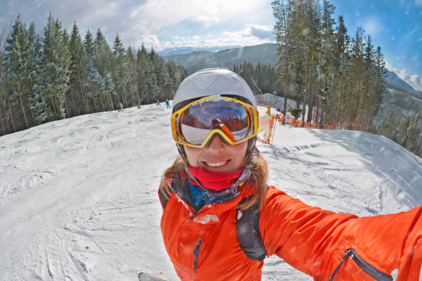 Happy woman taking selfie on winter  in Carpathian Mountains, Bukovel stock photo