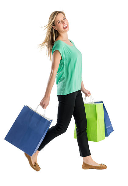 Happy Woman Walking With Shopping Bags stock photo