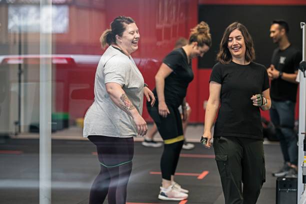 Happy women attending group fitness class stock photo