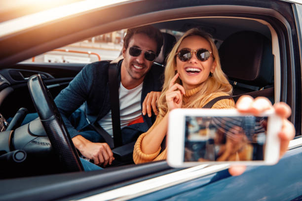 Happy young couple enjoying in drive stock photo