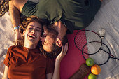 istock Happy young couple, lying on the picnic blanket, sharing affectionate to each-another, celebrating their love 1342036567