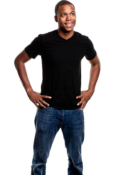 Happy Young Man Looking Up A smiling young African American male stands with hands on hips and looks upwards, isolated on white. http://s3.amazonaws.com/drbimages/m/courow.jpg hand on hip stock pictures, royalty-free photos & images