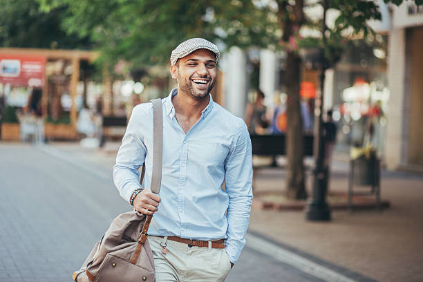 Happy young man Cheerful young man walking on the street. middle eastern culture stock pictures, royalty-free photos & images