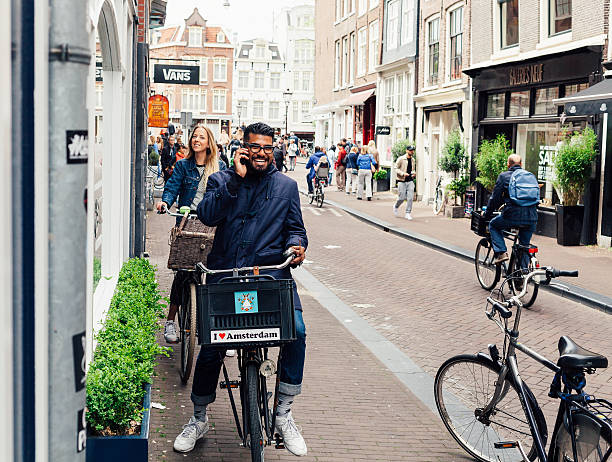 happy young people in amsterdam - amsterdam street imagens e fotografias de stock