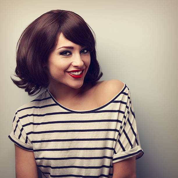 Happy young woman with short hairstyle toothy smiling. Vintage stock photo