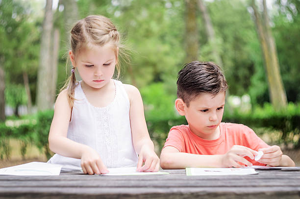 Hapy kids  learn in a park. Brother and sister together. stock photo