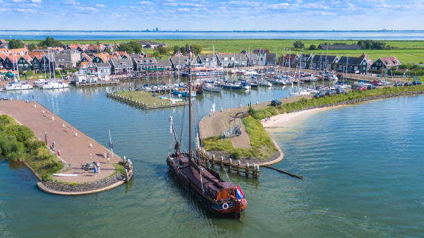 Harbour of Marken This photo is taken in Marken, a small island surrounded by lake Markenmeer in Noord-Holland. The lake is created by separating it from the sea with dikes. Marken is well known by its typically green wooden houses. In the far distance of the photo tall buildings rise from the city of Almere. flevoland stock pictures, royalty-free photos & images