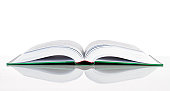 istock A hard cover book laid open on a white surface 157671792