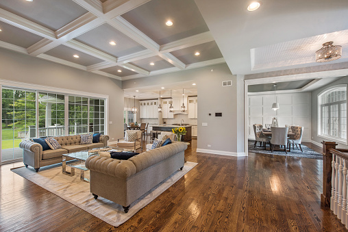 Great room with coffered ceiling and large windows