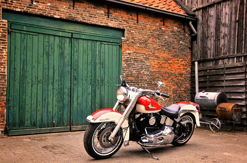 Kampen, The Netherlands - May 13, 2012: 1992 Harley Davidson Heritage Softail motorcycle in front of a barn.