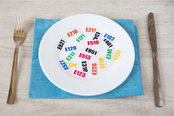 Harmful food additives. Harmful food additives. There are several tables with the code E-additives on the plate. food additive stock pictures, royalty-free photos & images