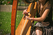 woman in the park play harp