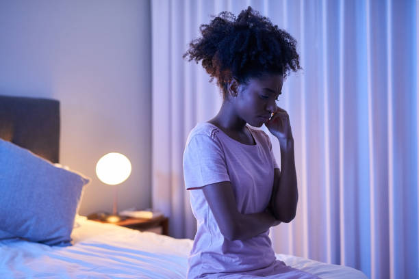 I hate it when I can't sleep Cropped shot of a young woman sitting alone in her bedroom insomnia stock pictures, royalty-free photos & images