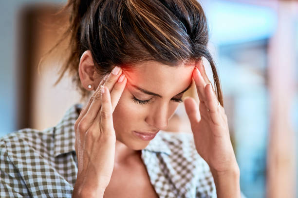 I have to keep away from focusing on the pain Shot of a uncomfortable looking woman holding her head in discomfort due to pain at home during the day headache stock pictures, royalty-free photos & images