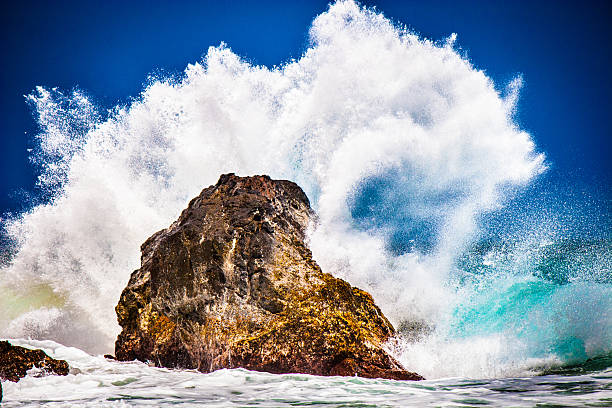Hawaii Ocean Wave Splashes Onto Rock stock photo