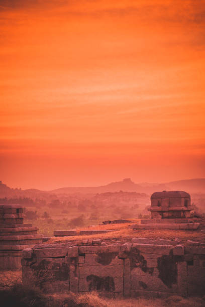 Hazy evening light after sunset in Hampi, India. Mistycal and hazy evening view, just minutes after sunset, overlooking the ancient ruins in Hampi, India. hampi stock pictures, royalty-free photos & images