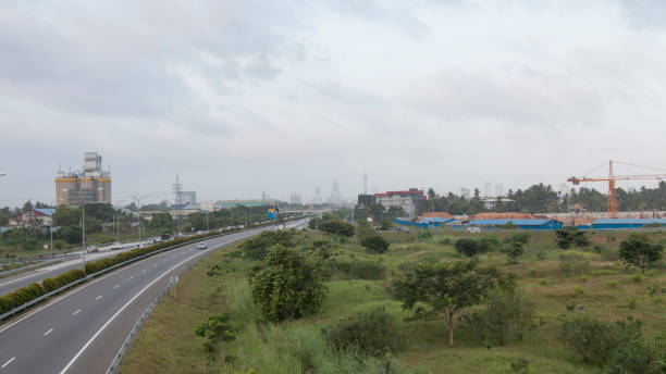 Hazy landscape of Colombo City, Sri Lanka partly covered in smog from Paliyagoda side highway. Lotus Tower & other under-construction buildings are partly visible in distance through the haze/smog. stock photo