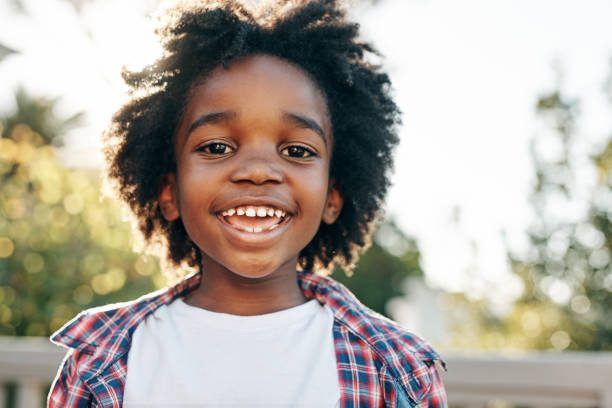 He is a summer child Portrait of a cheerful little boy smiling at the camera outside during the day africa photos stock pictures, royalty-free photos & images