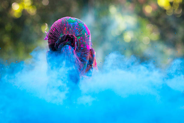 Head in Sea of Dye at Holi Festival Rear view of woman's head in a sea of colored dye at Holi festival in Jaipur, India. holi photos stock pictures, royalty-free photos & images
