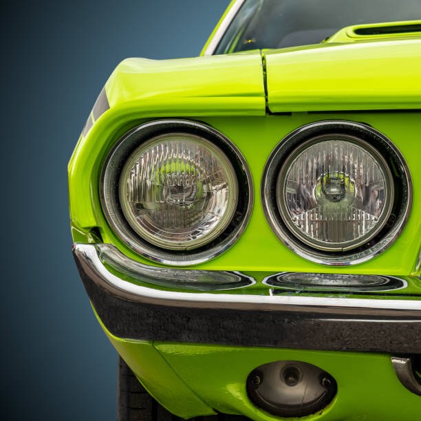 Headlights of a bright green American sports car stock photo