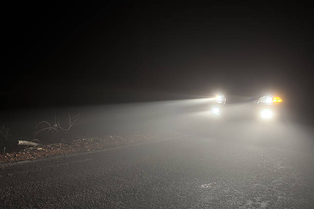Headlights of a car driving in the fog at night A shot of a car with its headlights and fog lamps on. Canon EOS 5D Mark II, Adobe RGB. headlight stock pictures, royalty-free photos & images
