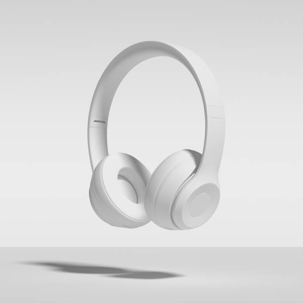 Headphones Isolated On White Background. Abstract Image of White Painted Headphones, Falling, Floating, Suspended, Isolated Against White stock photo