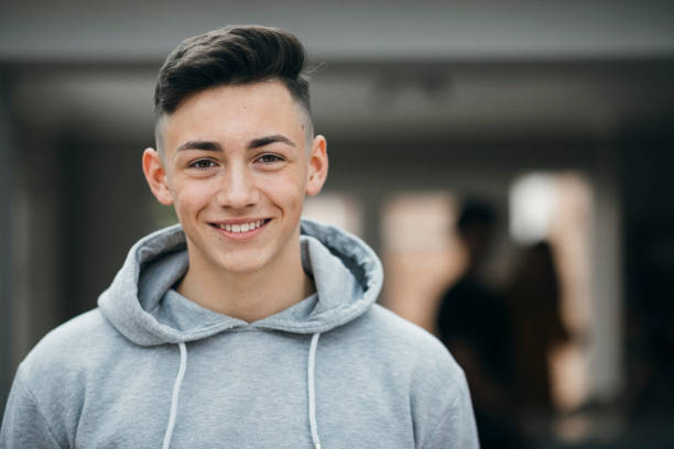 Headshot of a Teenage Boy Portrait of a smiling teenager looking at the camera and smiling. teenager stock pictures, royalty-free photos & images