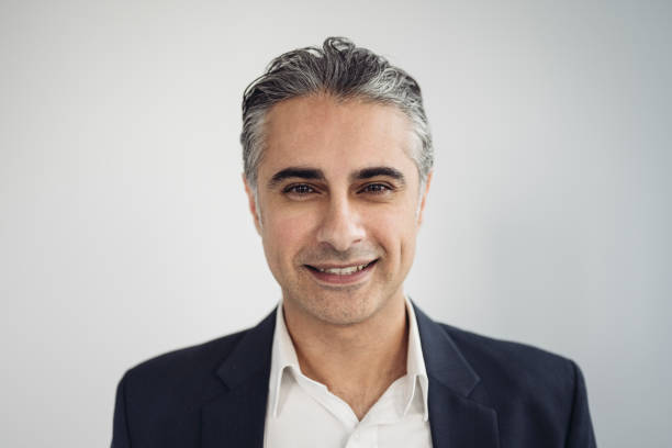 Headshot of early 40s Middle Eastern corporate executive stock photo