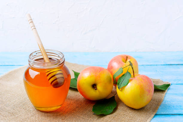 Heallthy eating concept with honey and fresh apples Heallthy eating concept with glass honey jar and fresh ripe apples. Jewesh new year symbols. Rosh hashanah concept. sites of japan's meiji industrial revolution stock pictures, royalty-free photos & images