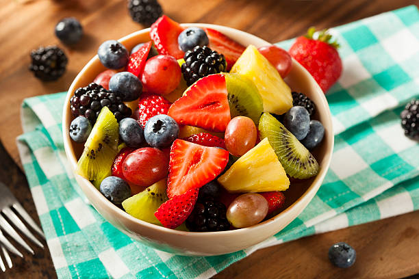 Heallthy Organic Fruit Salad Heallthy Organic Fruit Salad with Berries Pineapple and Grapes fruit salad stock pictures, royalty-free photos & images
