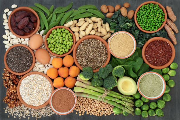 Health Food High in Protein Health food  high in protein with legumes, fresh vegetables, dried fruit, grains, dairy, supplement powders, seeds and nuts. Super foods high in dietary fibre, vitamins and antioxidants. Top view. pea protein powder stock pictures, royalty-free photos & images