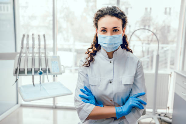Healthcare and medicine concept. Portrait of female dentist. She standing at her office in mask. dentists office stock pictures, royalty-free photos & images