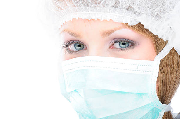 Healthcare professional wearing a surgical mask stock photo