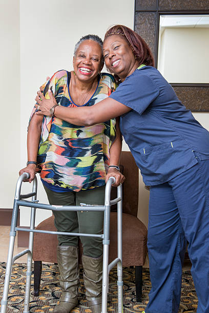 Healthcare Worker and Senior Woman Share a Victory stock photo