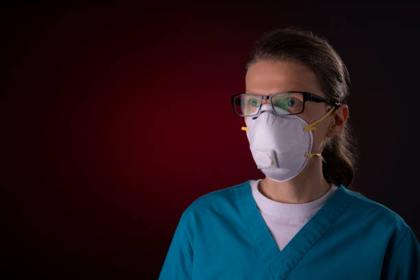 COVID-19 healthcare worker using PPE protective equipment COVID-19 healthcare worker using PPE protective equipment. Nurse or doctor theme preparing for virus treatment. n95 mask stock pictures, royalty-free photos & images
