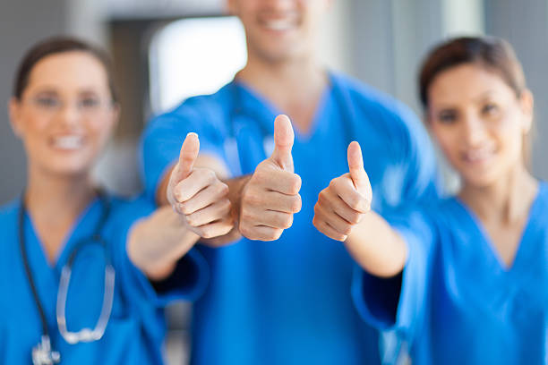 healthcare workers thumbs up stock photo