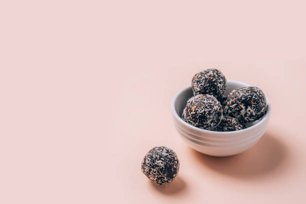 Healthy energy balls made of dried fruits and nuts with coconut chips, flax seeds, pistachios, sesame. stock photo