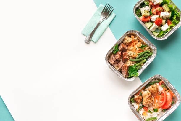 Healthy food delivery Healthy food delivery. Take away of organic daily meal on blue, copy space. Clean eating concept, healthy food, fitness nutrition take away in foil boxes, top view. take out food stock pictures, royalty-free photos & images