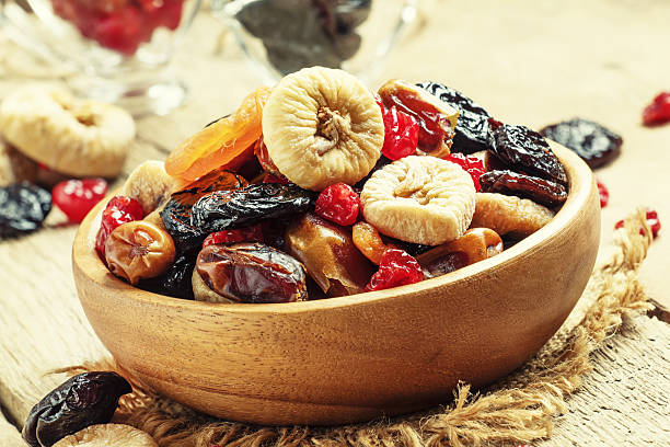 Healthy food: mix from dried fruits Healthy food: mix from dried fruits in bowl, old wooden background, selective focus dried fruit stock pictures, royalty-free photos & images